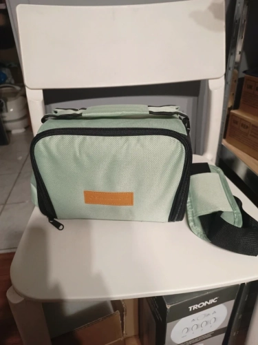 Miętowa materiałowa torba termiczna lunch box trzymana za górny szeroki pas