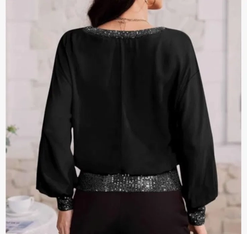 Nowa elegancka czarna bluzka damska w rozmiarze L z długim rękawem oraz błyszczącymi cekinami wokół dekoltu mankietów i na dole topu